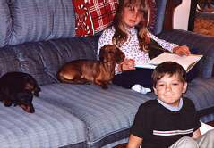 d and h on couch with pups
